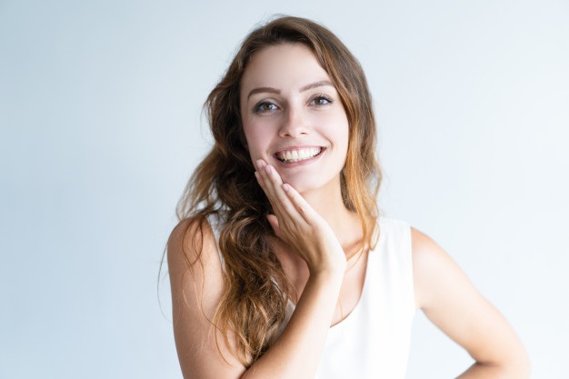 smiling young lovely woman looking at camera and touching face 1262 15247